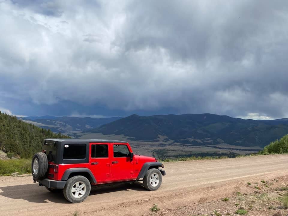 red Jeep overlooking valley